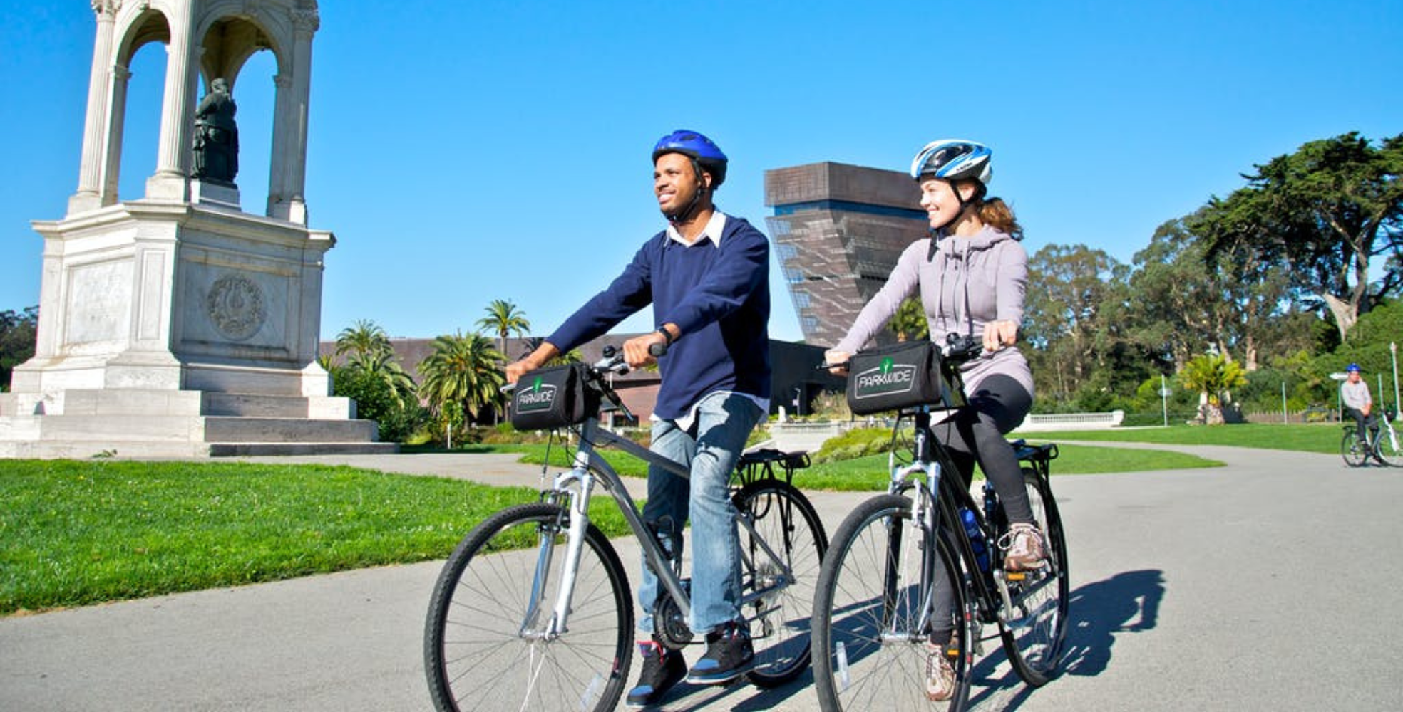 couple biking through golden gate park on bike rentals