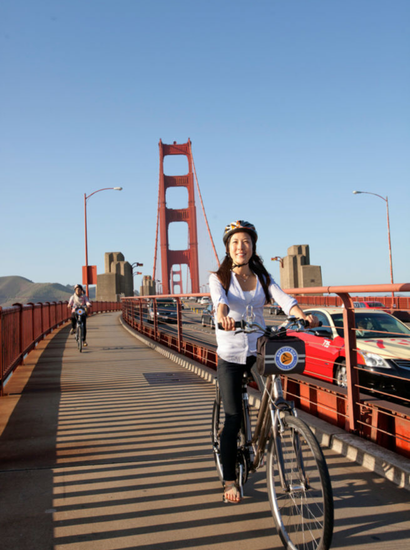 couple biking the san francisco golden gate bridge on guided bike tour